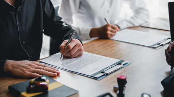 Business owner signing legal document