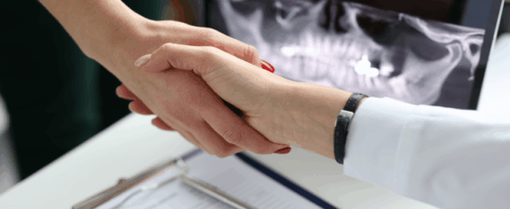 A doctor shaking hands with a seller.