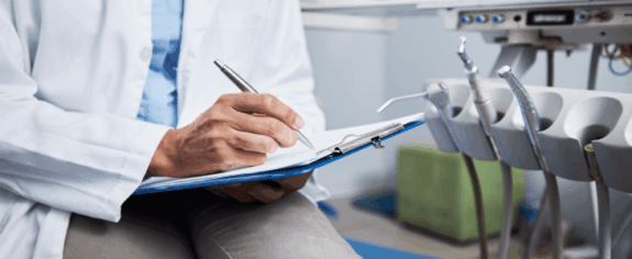 A veterinarian writing on paper.