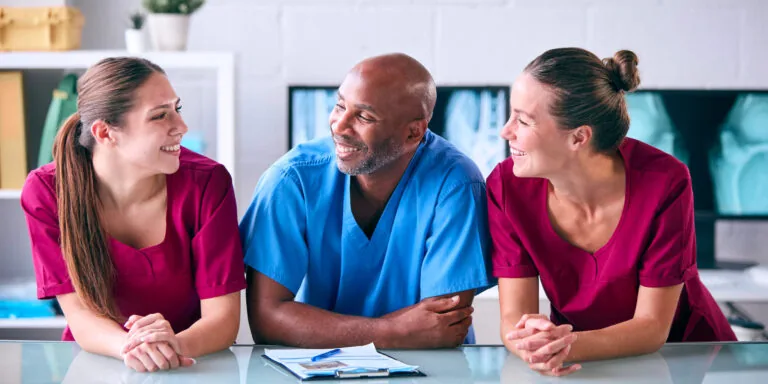Portrait Of Male And Female Veterinary Team In Surgery
